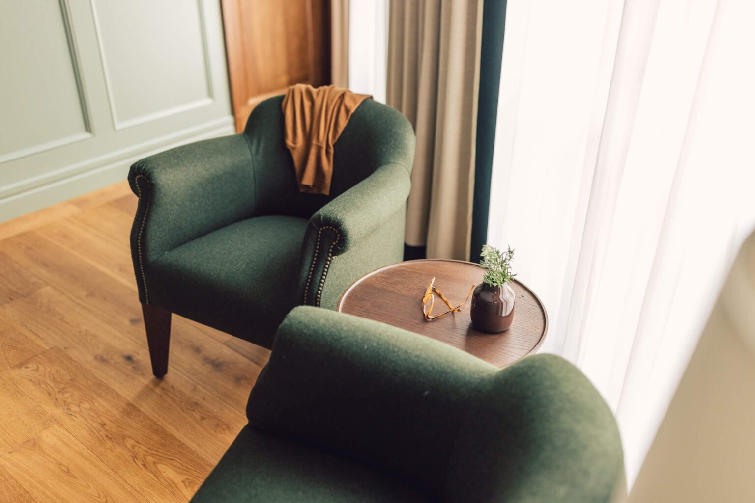 Helle Sitzecke mit hochwertigen Polstersesseln im Taube Classic Zimmer.